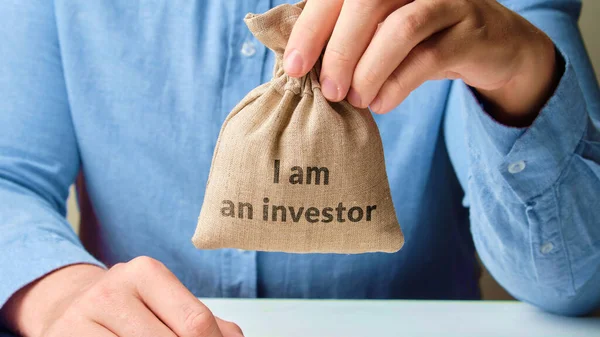 Concepto Inversión Empresarial Persona Está Sosteniendo Una Bolsa Abstracta Dinero —  Fotos de Stock