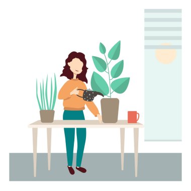 Ofisteki masasında duran bir kız çiçekleri suluyor..