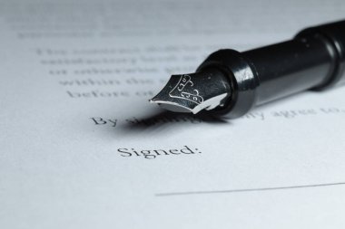 Fountain Pen placed next to signature blank