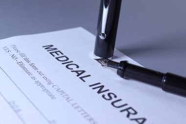 Medical Insurance Form with pen lain across the page
