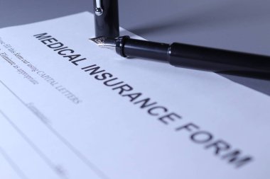 Medical Insurance Form with pen lain across the page