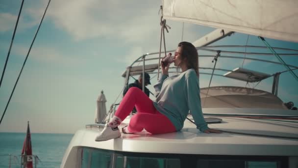 Молода жінка розслабляється на яхтній палубі — стокове відео