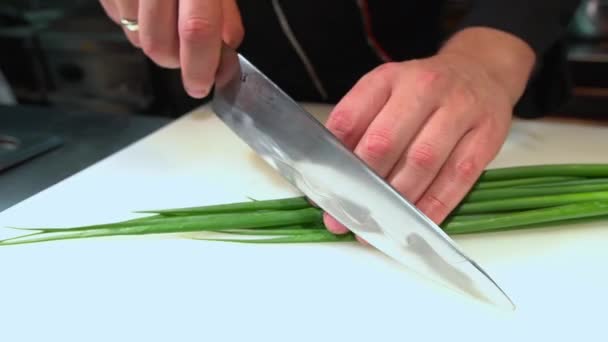 Chopping Fresh Green Onion Into Peaces On White Cutting Board — Stock Video