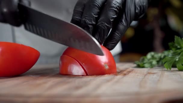 Chef cut, dicing tomatoes into cubes on a wooden board. Chefs hands in gloves. — Stock Video