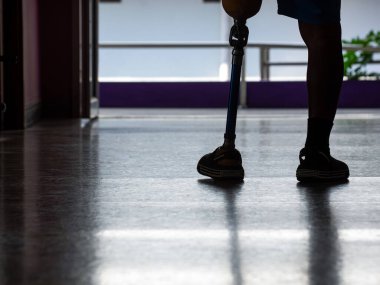 Behind the man wearing prosthetic legs walked out the door.