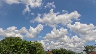 Bir yerleşim yerinin çatısından görülen beyaz bulutların zaman akışı tropikal iklimde hava değişiklikleri