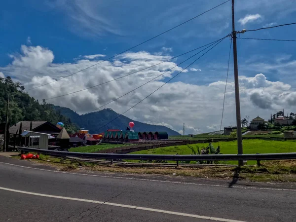 Dağlık bölgelerdeki doğal manzara serin hava, açık ve güneşli gökyüzü sakin yol koşulları ve yeşil bitkiler temiz hava sağlıyor.