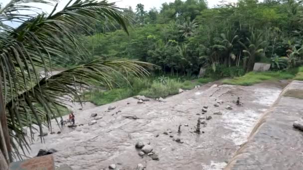 泥や火山灰を運ぶために曇っている滝の景色は ジャワ島のメラピ山の噴火による冷たい溶岩の流れの道です — ストック動画