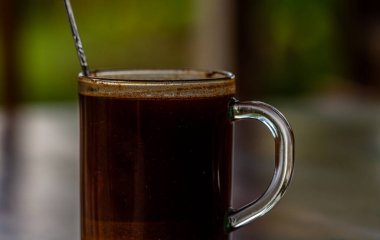 A cup of brewed coffee from the bean robusta type, used as a mood booster drink to start the activity