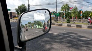 SLEMAN, INDONESIA - AUGUST 06, 2022. Traffic situation on the Yogyakarta-Magelang road on weekdays, community activities after the covid-19 pandemic