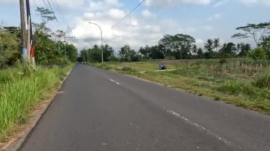 Yogyakarta, Indonesia - August 25, 2022. Traffic situation on Jalan Kebonagung Sleman, a small road supporting the new Yogyakarta-Bawen toll road section