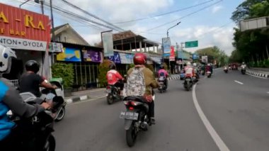 Yogyakarta, Indonesia - August 25, 2022. Traffic situation at the Denggung-Sleman traffic light at noon during working hours, Area around the Sleman Regency Regional Government complex