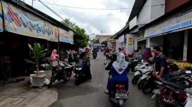 Sleman, Indonesia - August 30, 2022. The situation on the ring road of the Sleman Traditional Market, which is used as a parking lot, will be very congested and crowded at peak times