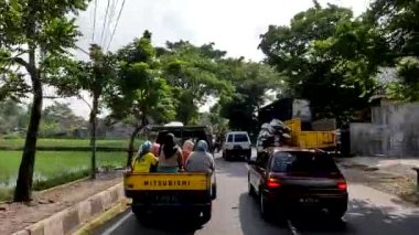 Magelang, Indonesia - August 30, 2022. The use of freight cars to transport passengers in the Muntilan area of Central Java, transportation needs on the outskirts and the lower class