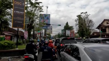 Sleman, Indonesia - August 30, 2022. There are more motorcycle riders stopping at a traffic light than cars, Beran Sleman Traffic light, Yogyakarta