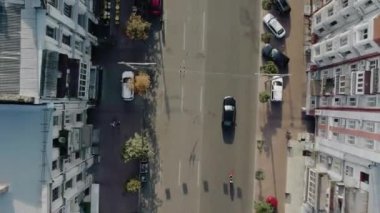 the car is moving fast on a straight road a moped follows her