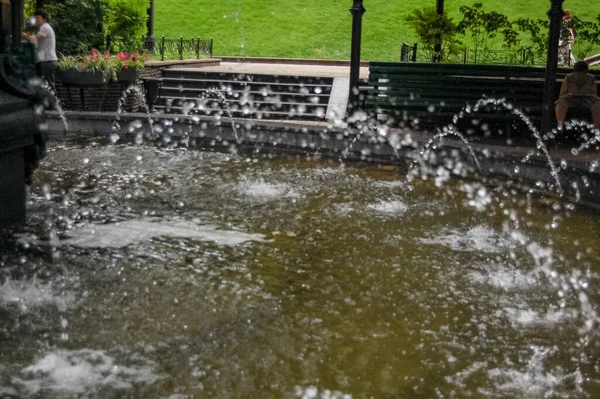 Şehir parkının fıskiyesi suyu yakın plan akıyor.