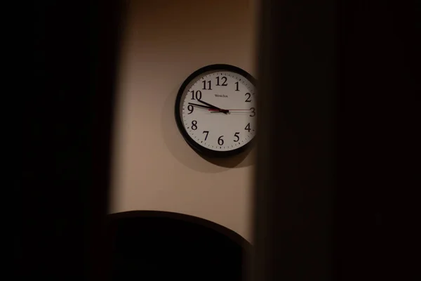 Looking at the clock on the wall