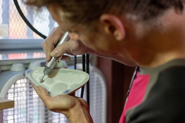 A man making a ceramic ocarina