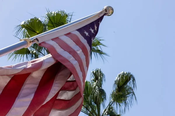 The American flag with the blue sky