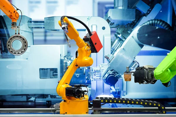 Endüstriyel kaynak robotu ve metal parçalarıyla çalışan sürükleyici robot akıllı fabrika, makine mavisi renk arkaplanı, endüstri 4.0 ve yapay zeka, otomasyon robotu insan kontrolü olmadan çalışıyor 