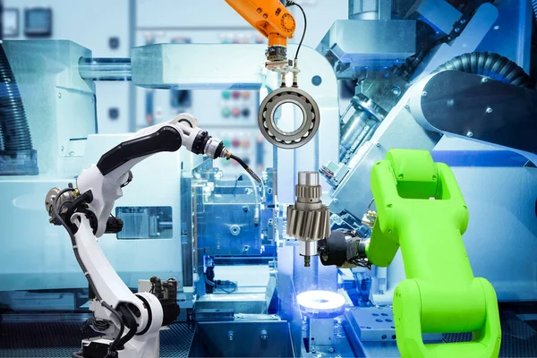 Industrial welding robot and gripping robot working with metal parts on smart factory, on machine blue tone color background, industry 4.0 and AI, automation robotic working via no people control