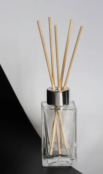 home diffuser with incense sticks on blue and white background
