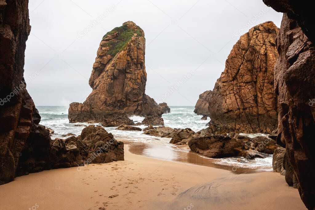 Beautiful landscape of sandy ocean beach with stones and rocks