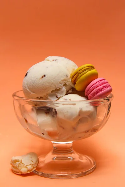 Close-up view of ice cream bowl. Peach colour background