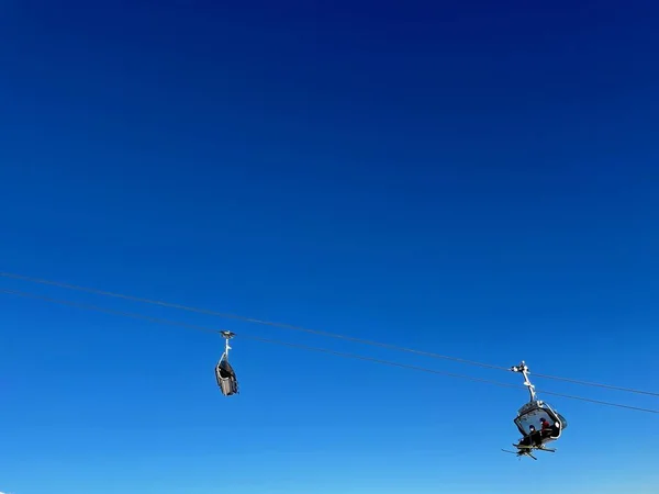 Chairlift against blue sky in winter ski resort Golm, Montafon, Austria. — Stockfoto