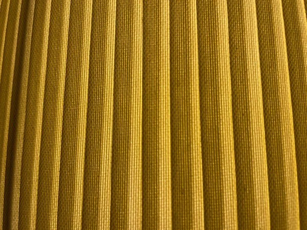 Closeup of the yellow fabric of a table lamp. — стоковое фото