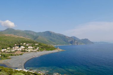 Panoramic view of black pebble beach and Genoese tower of Albo, Cap Corse. Corsica, France. clipart