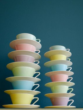 Benzin arka planında renkli çay ve kahve fincanları yığını. Dikey. Yüksek kalite fotoğraf