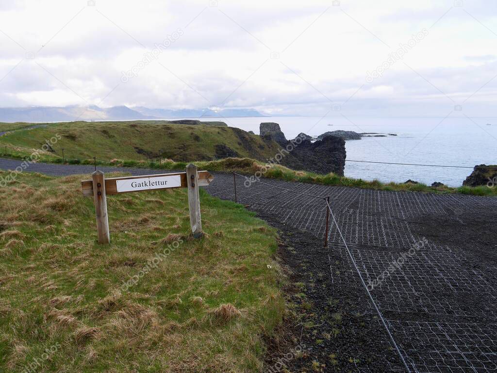 Sign indicating way to famous Gatklettur basalt rock arch in Snaefellsnes Peninsula National Park. Arnarstapi, Iceland. High quality photo