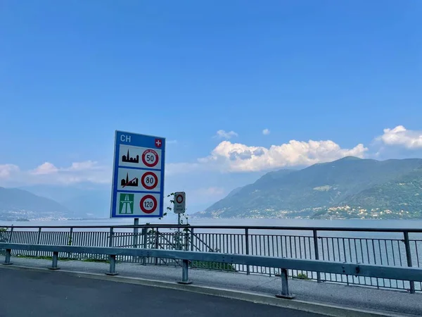 Country border sign at Swiss Italian border crossing Valmara Brissago at Lago Maggiore, Piedmont, Italy. High quality photo