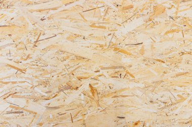 Baskılı ahşap talaşı panel arka planı. OSB kağıdı, ahşap bir zemine sıkıştırılmış kahverengi ahşap parçalardan oluşur..