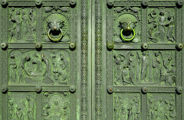 Bremen, Germany - July 13, 2022: Entrance of the Bremer Dom in Germany, Bremen. Green old entrance gate with christian decoration.