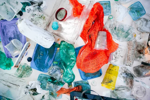 Plastic waste and garbage collected from the ocean. Pile of colorful junk with plastic bottles, bags, cups and other packaging