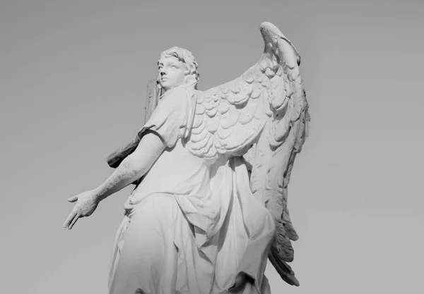 Statue of angel with wings in front of the Karlskirche in Vienna. Stone sculpture of a angelic beautiful woman. Concept for christian religion architecture