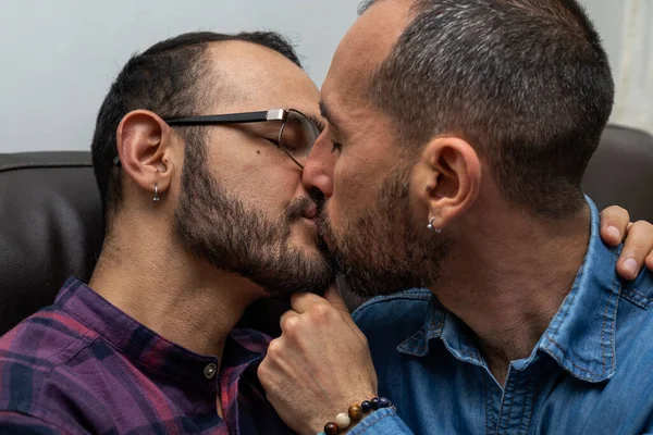 Real couple of Latin American men kiss with love. Concept of sexual diversity