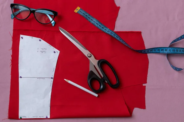Sewing pattern with scissors and tape measure.