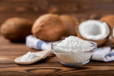 Kâsede hindistan cevizi gevreği, ahşap arka planda hindistan cevizi. Yakın plan..