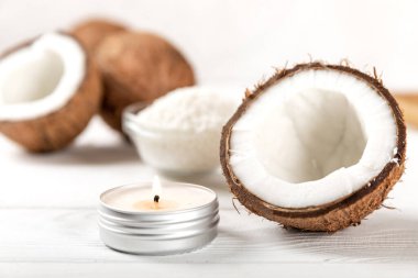 Hindistan cevizi aromalı soya doğal mumu. Metal bir şamdanda Hindistan cevizi aromalı ve posalı. Gri çimento üzerine kompozisyon. Organik ürün. Yan görünüm.