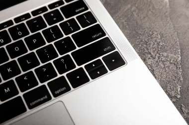 Laptop keyboard.Top view of laptop with black keyboard on black texture background.Copy space. Place for text.MOCKUP