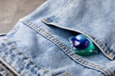 Siyah mermer arka planda mavi kotlu çamaşır kapsülleri. Çamaşır makinesinde çamaşır yıkamak için deterjan. Saflık kavramı. Metin için yer.