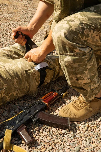 Army medics practice applying a tourniquet to the leg of a wounded soldier. Combat tactical equipment. Combat use Turnstile. The concept of military medicine.