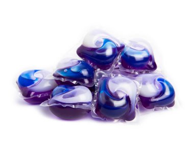 Çamaşır deterjanı yıkama kapsülleri çamaşır makinesinde çamaşır yıkamak için beyaz arka planda izole edilmiş. Saflık kavramı. Metin için yer.