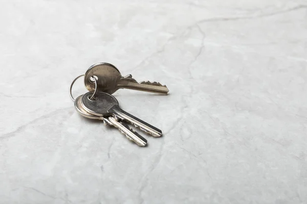 House keys .Composition on gray marble background.Design element.Real estate and insurance concept.Copy space.