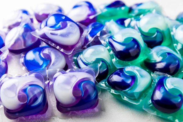 Washing capsules. Capsules with liquid powder for washing things in the washing machine. Capsules background.