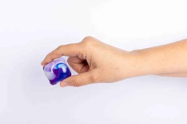 Capsules for washing in hands. washing powders for washing clothes in a washing machine isolated on a white background. The concept of purity. Place for text.